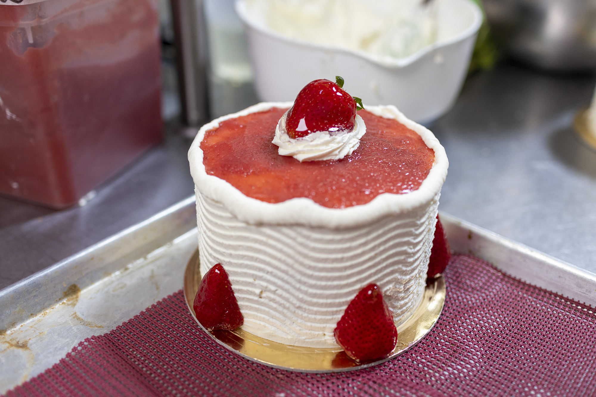 Strawberry and vanilla cake decorated with glazed strawberries