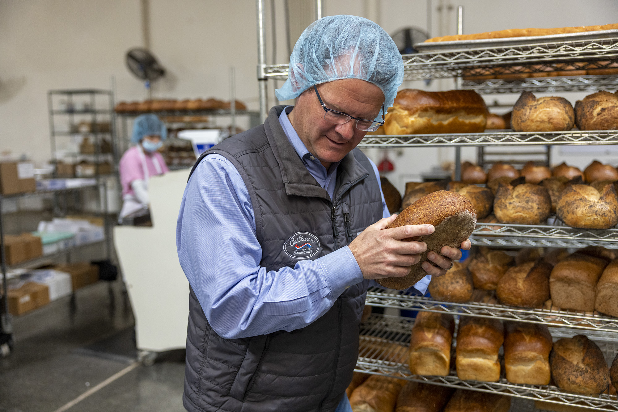 Costeaux French Bakery owner, Will Seppi, inspecting bread.