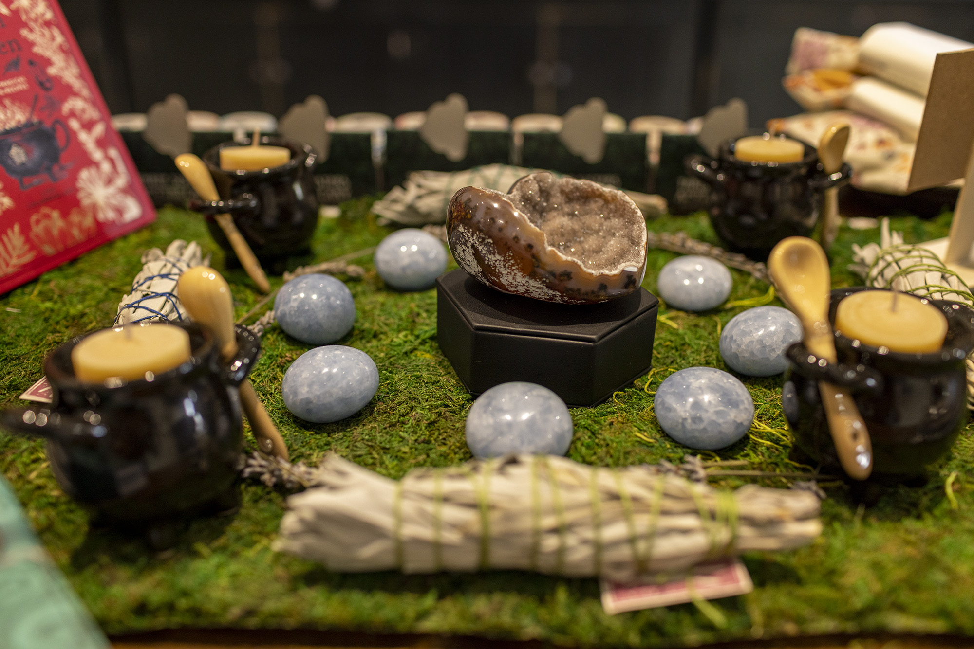 Polished stones, sages, and cauldron shaped tea candle holders.