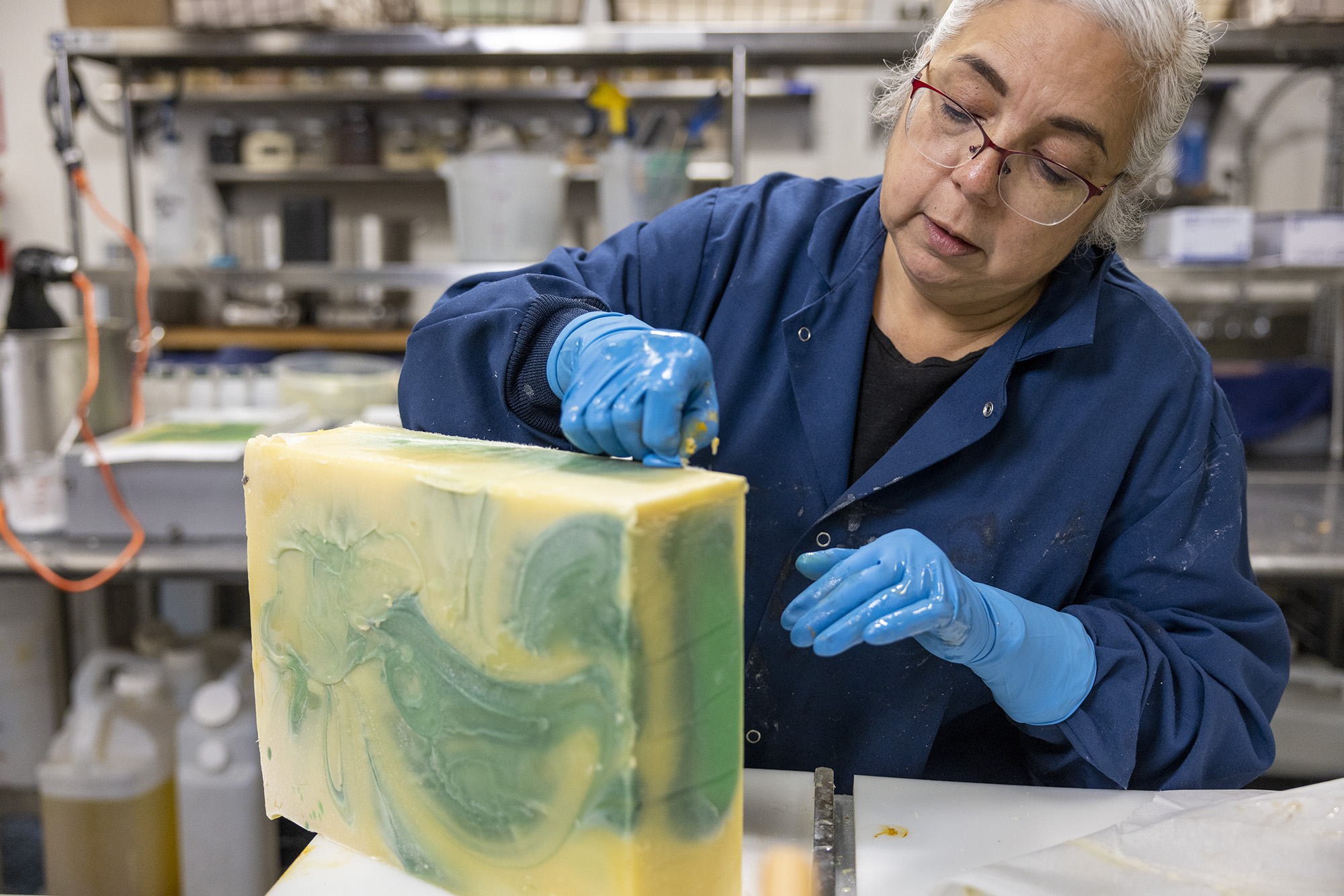 Owner and founder of Soap Cauldron, Emma Mann, preparing large block of soap for cutting.