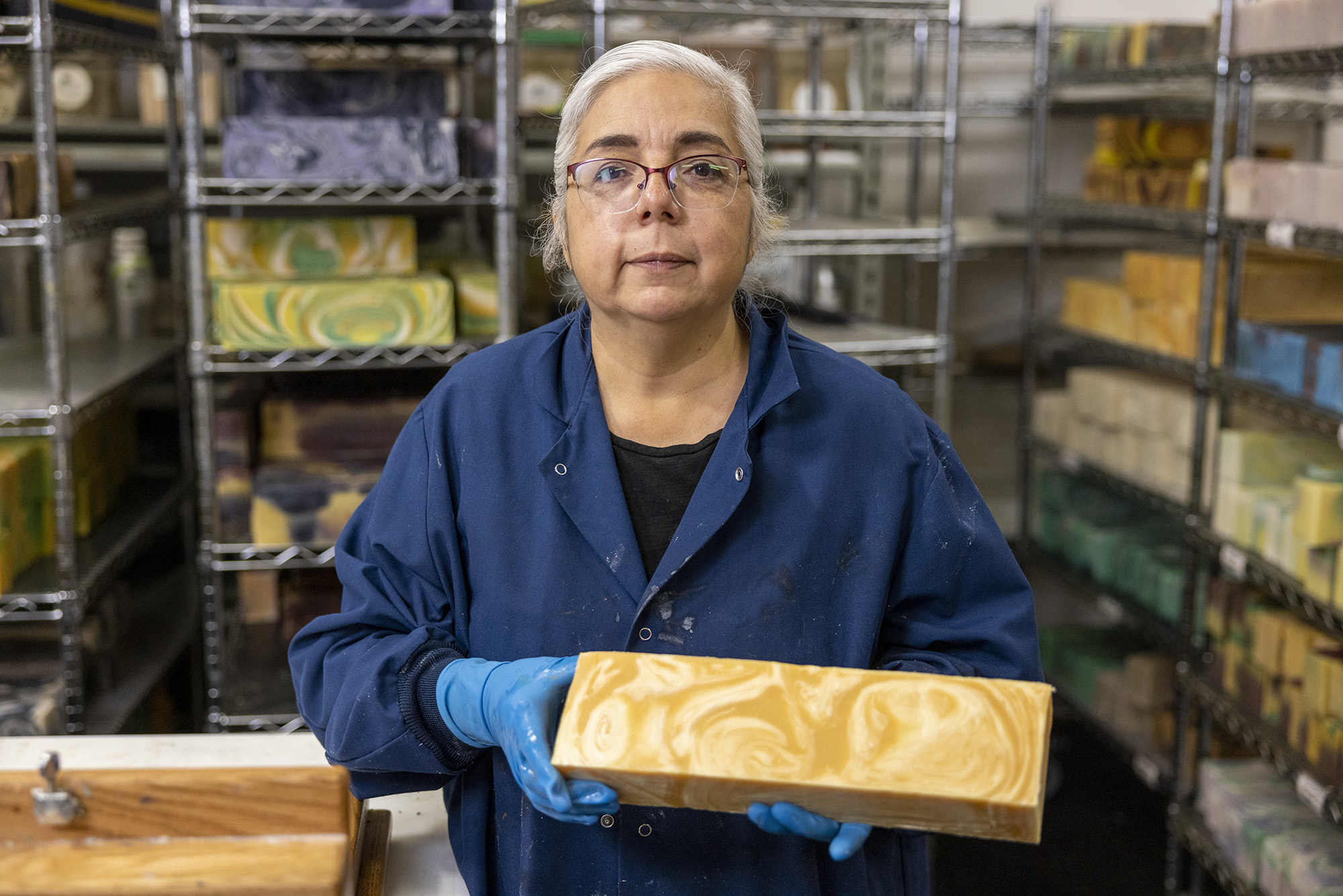 Owner and founder of Soap Cauldron, Emma Mann, holding up large block of soap