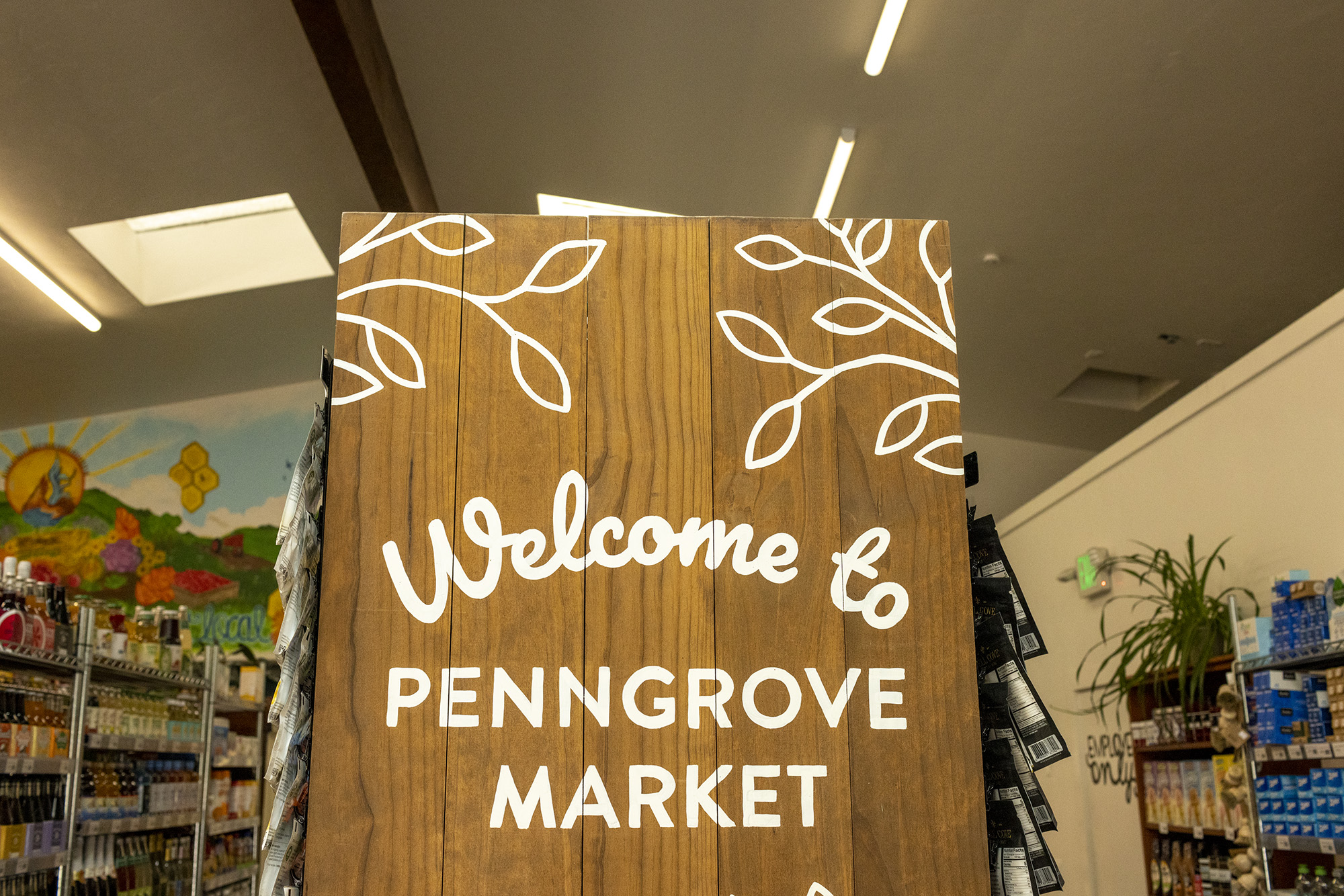 Welcome to Penngrove Market sign located at end of grocery aisle.