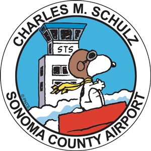 Charles M Schulz Sonoma County Airport STS logo. Snoopy pretending to be the Red Barron, riding past the STS tower.
