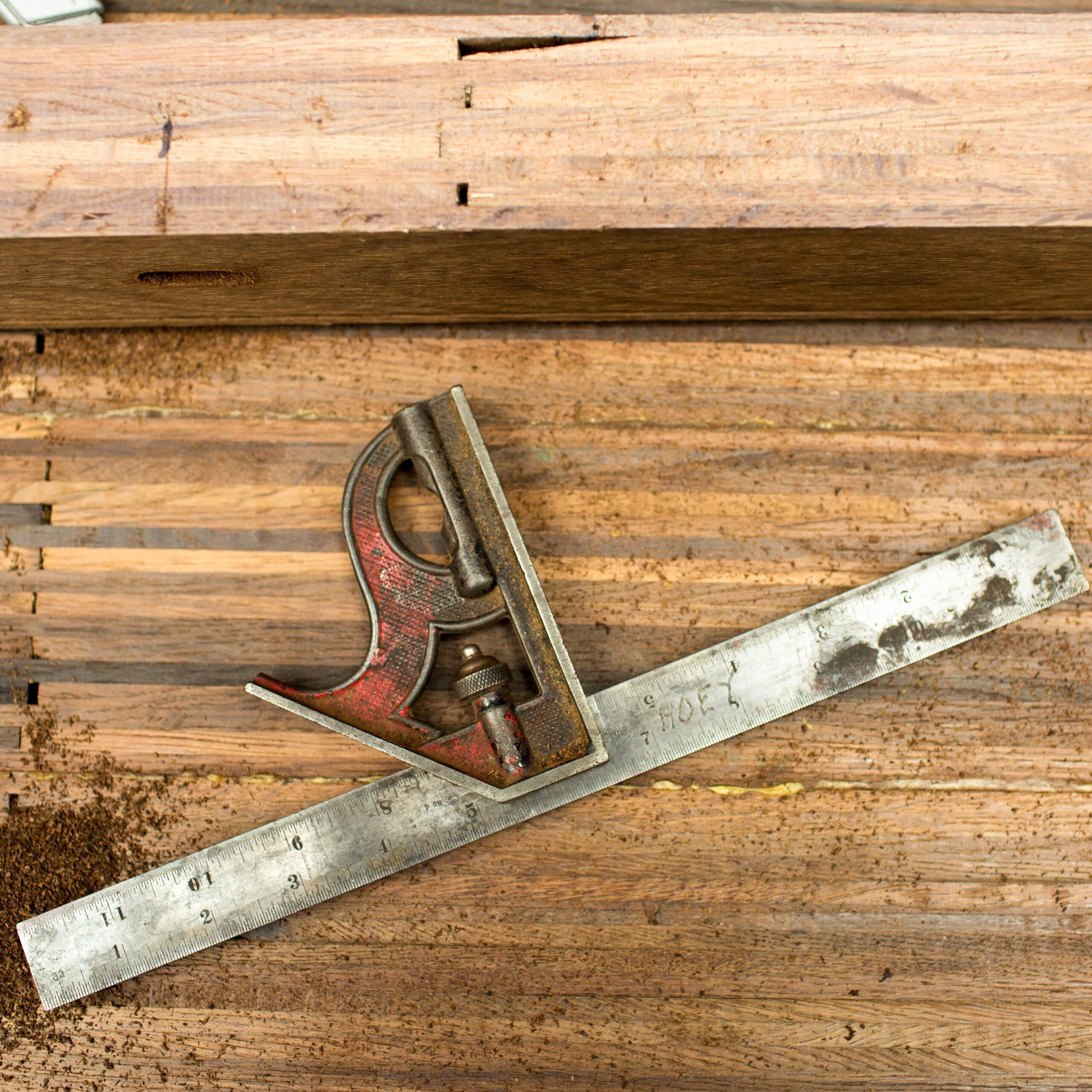 Well worn tool resting on lumber.